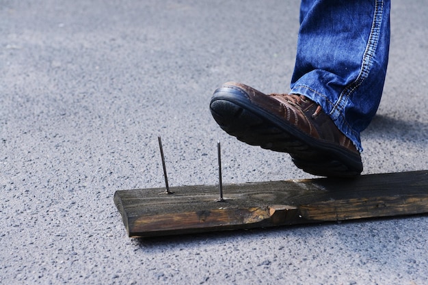 Worker steps on nail outdoors