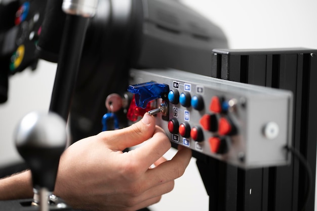 A worker turning on the toggle switch up industrial power control panel