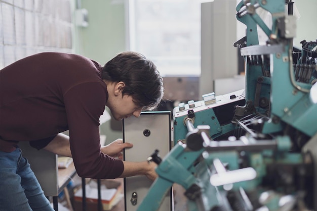 worker at the typography printing newspaper or journal b