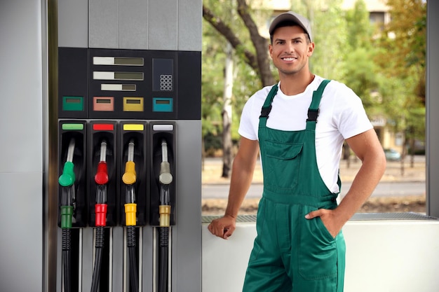 Worker in uniform at modern gas station