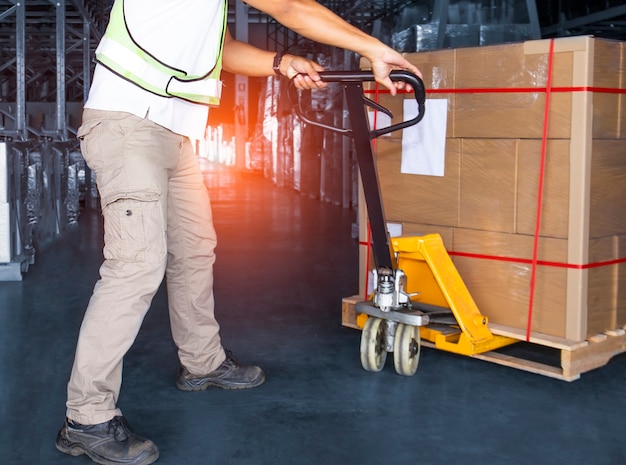 Worker Unloading Package Boxes in Storage Warehouse Shipment Boxes Shipping Warehouse Logistics