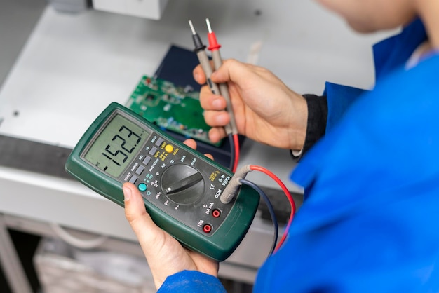 worker use electric multimeter and check voltage b