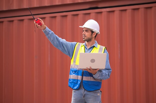 Worker using computer in containers export background Engineer using computer in containers import background