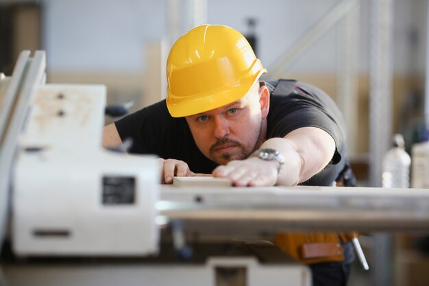 Worker using electric saw portrait