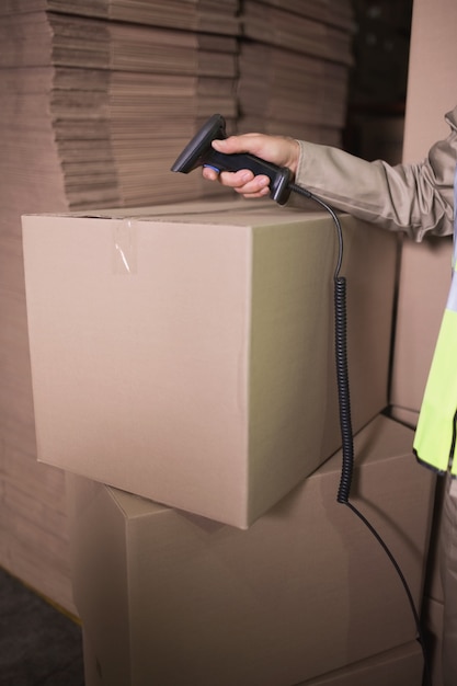 Worker using scanner in warehouse