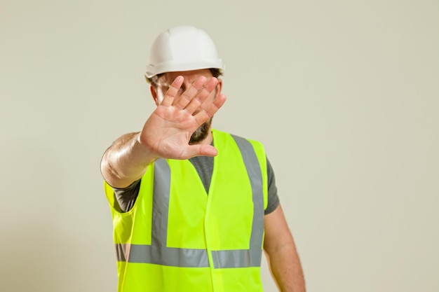 Worker in a vest and white helmet