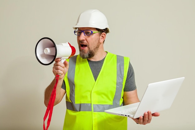 Worker in a vest and white helmet