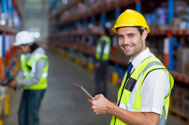 Worker in warehouse looking at camera