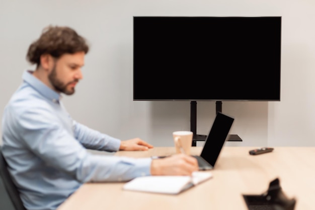 Photo worker watching webinar focus on monitor with black empty screen