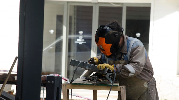 worker welding blacksmith working with protective clothing