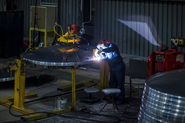 Worker welding in factory