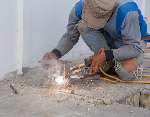 worker welding metal