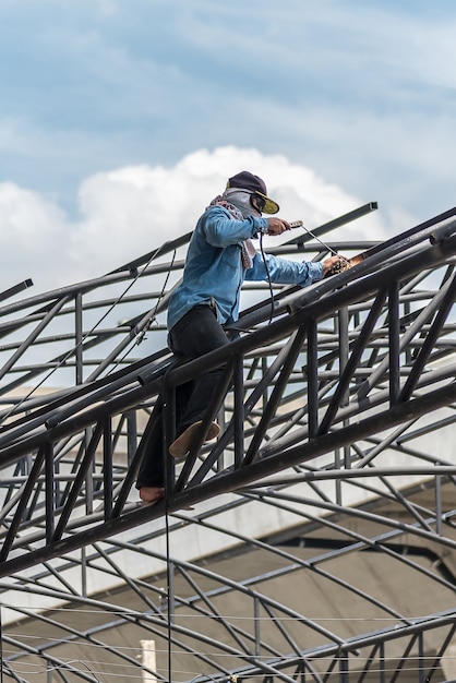 Worker welding the steel part