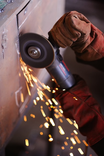 Worker with angle grinder