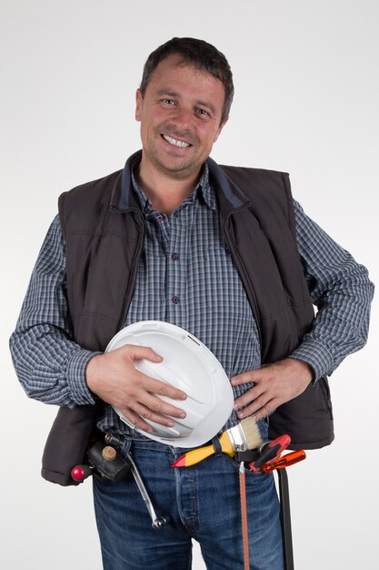 A worker with helmet and tools isolated