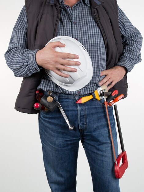 A worker with helmet and tools isolated 