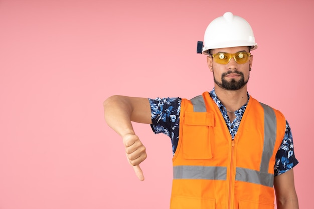 Worker with reflective vest pointing his thumb down