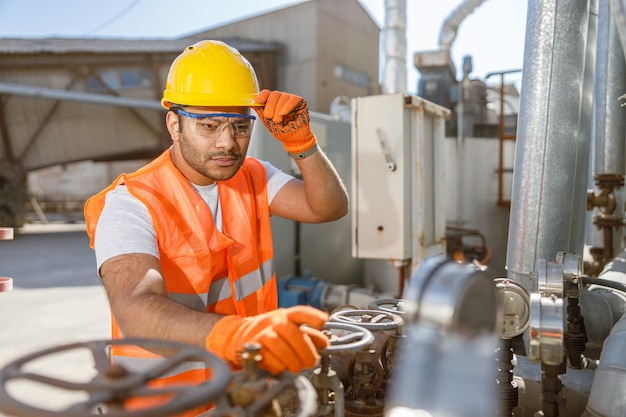 Photo worker with safety equipment working at construction plant