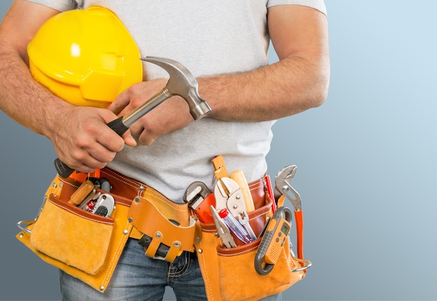 Worker with a tool belt. Isolated over  background.