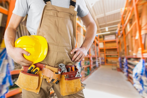 Worker with a tool belt. Isolated over  background.