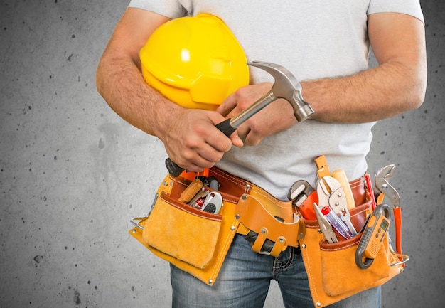 Worker with a tool belt. Isolated over  background.