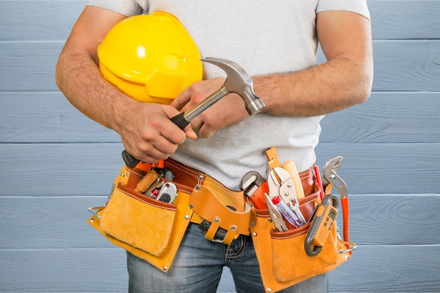 Worker with a tool belt. Isolated over white background.