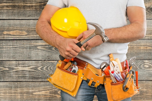Photo worker with a tool belt. isolated over white background.