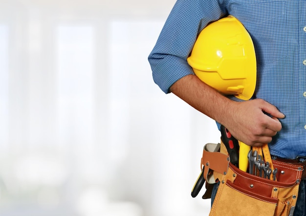 Worker with a tool belt. Isolated over white background.