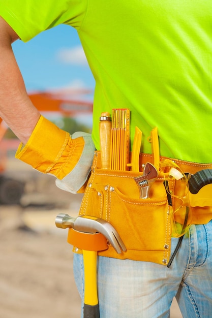 Worker with tools in belt