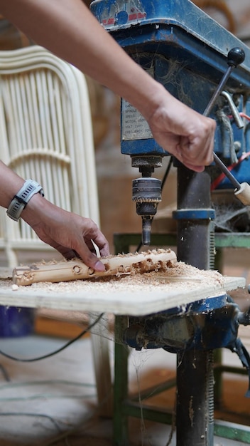 a worker with a wood drill