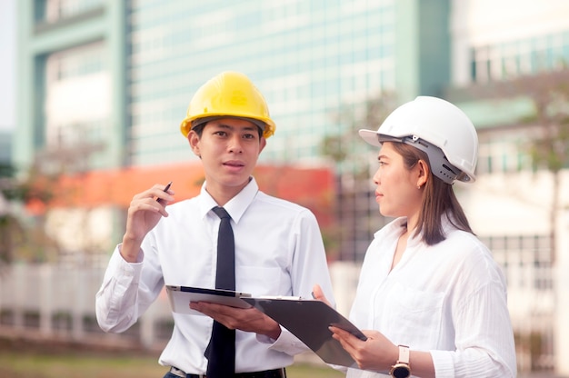 Worker women talking to worker man holding a tablet