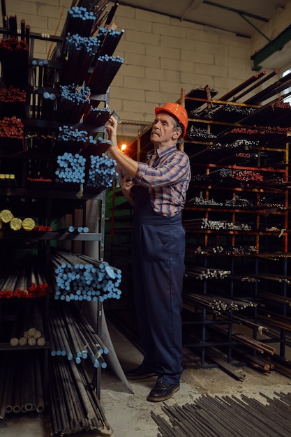 Worker working with metal pipes