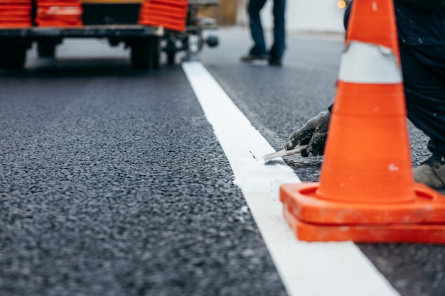 Photo workers applying new road markings outside the city