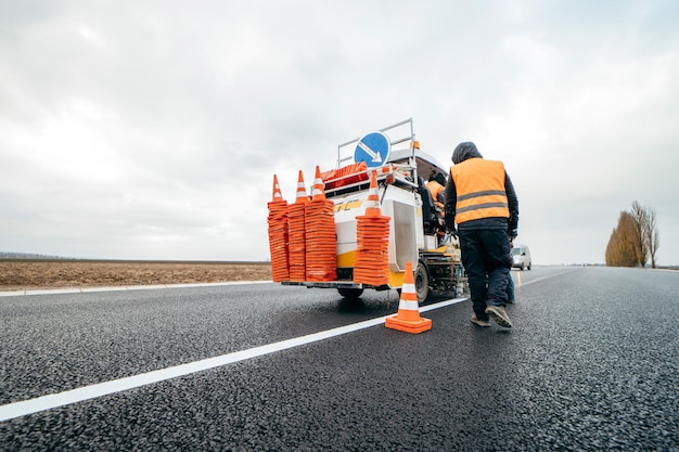 Workers applying new road markings outside the city