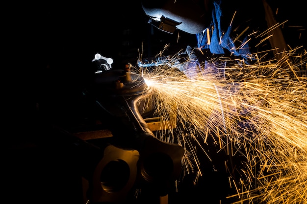 Workers are grooving with carbon welding wires With sparks