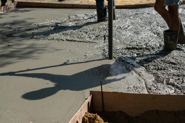 Workers are pouring concrete and equipment