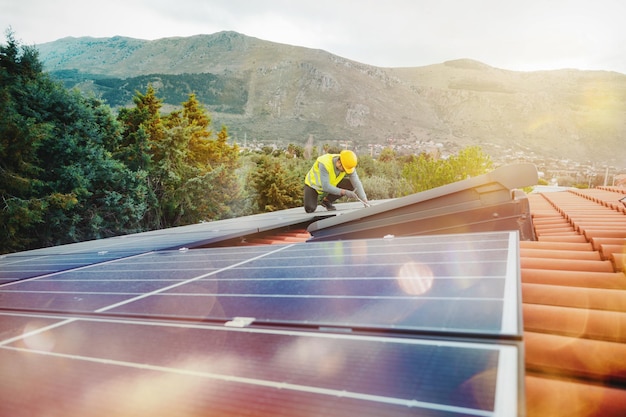 Workers assemble energy system with solar panel for\
electricity