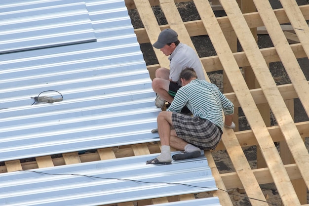 Workers building roof