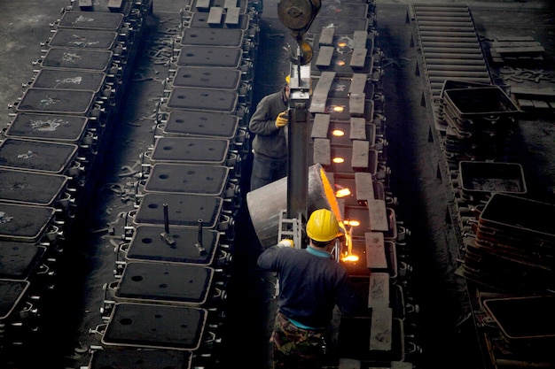 Workers in a foundry at the melting furnace