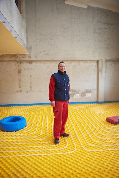 workers installing underfloor heating system