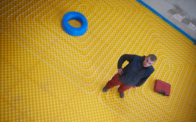 workers installing underfloor heating system