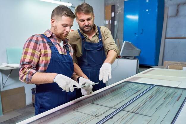 Workers Operating Glass Engraving Machine