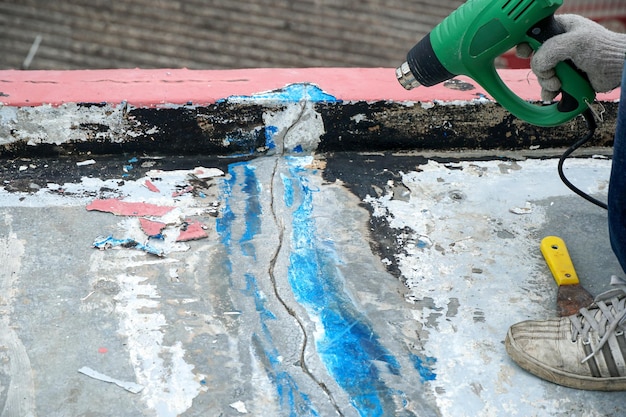 Workers repairing roof cracks