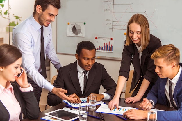 Workers show schedules of achievements in work to director.