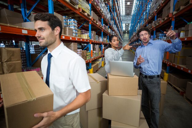 Workers talking and pointing shelves