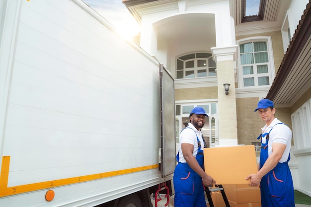 Photo workers unloading boxes from van outdoors moving service and customer need for move to new house