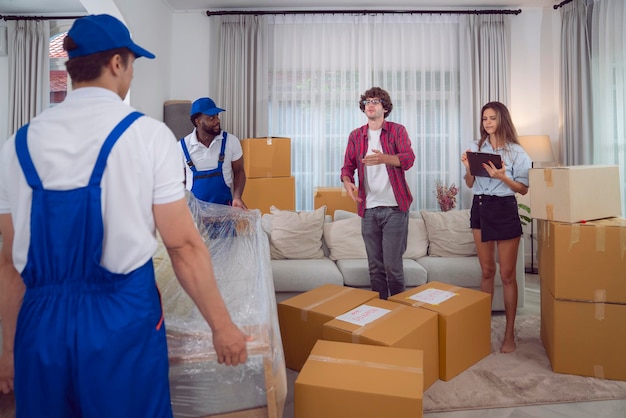 Photo workers unloading boxes from van outdoors moving service and customer need for move to new house