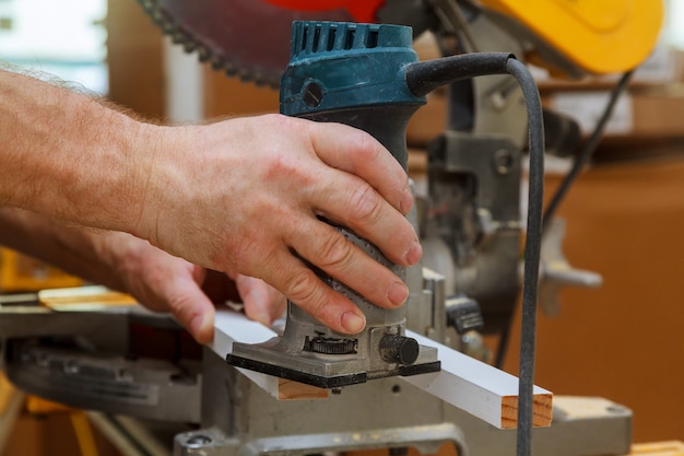 Workers using electric routering to cut down stripes