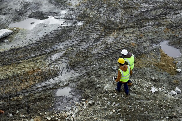 Workers Walking in Dirt on Site