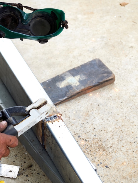 Workers weld the iron .